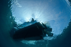 Martyn waits on the boat for divers to return.  Canon 20D... by Mick Tait 